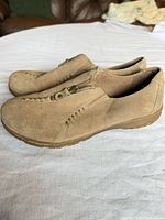 Side view of both shoes showing suede uppers, stitching, zipper, and sole