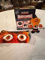 Game box, plush figure and headband displayed together