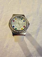 Front view of watch showing rhinestone bezel and multicolour markers