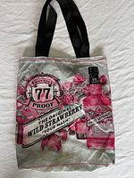 Front view of Sweet Revenge satin tote showing full graphic and handles