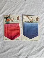 Front view of both sealed Pockets & Peekers packages displaying red-pink and blue pockets