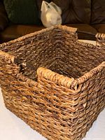 Angled view showing interior, weave pattern, wooden handle rods