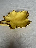 Top view showing yellow maple leaf dish with gold edging