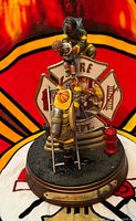 Front view of Bradford Exchange Courage Under Fire figurine showing firefighters, child, Fire Dept emblem, base