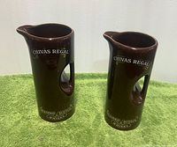 Front view of both brown Chivas Regal pitchers showing logos