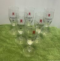 Front view of six Michelob stem glasses displaying logos