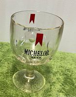 Front view showing Michelob logo and red ribbon on goblet