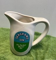 Front view of white ceramic Seagram's Gin pitcher showing logo