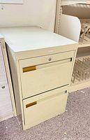 Front view of closed beige two-drawer file cabinet