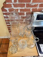 Group shot of all eight clear glass items on countertop