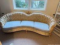 Front view of entire sofa showing carved frame, tufted back and cushions
