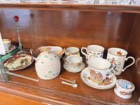 Overall view of lot showing honey pot, commemorative china, leaf dishes, trinket box, glass rose and spoons