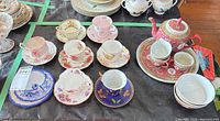 Overview of lot showing teacups, saucers, teapot set and bowls