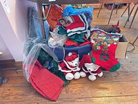 Overview of tote with stockings, plush bears, wreath, garland and fabric items