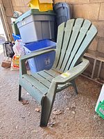 Front angled view of entire green plastic Adirondack chair