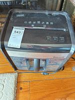 Top and front view of Staples MailMate SPL-TXC12M7A shredder showing control panel, slot, bin and power cord