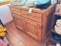 Front view of pine cabinet showing drawers and doors