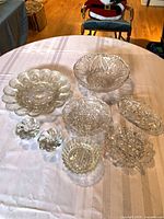 Group view of all eight clear glass pieces on table