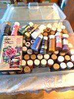 Clear bin showing numerous acrylic paint bottles of various colours