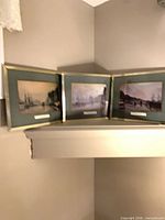 Three matching framed Liverpool waterfront prints on shelf
