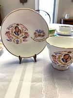 Commemorative bone china cup and saucer with portrait and gold trim