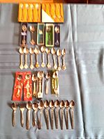 All spoons and fork laid out on table