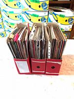 Three red magazine holders filled with assorted craft magazines