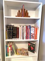 Full bookshelf view showing wooden bookends and all books