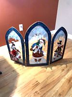 Metal trifold Christmas screen standing open