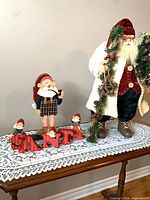 Tabletop view showing both Santa figures and SANTA letters with elves