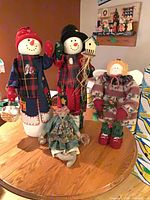 All four fabric holiday figures displayed on table