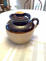 Full view of two-tone bean pot with lid on table