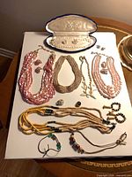 Entire grouping laid out showing all necklaces, bracelet, earrings and single earring