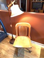 Oak swivel chair and floor lamp full view
