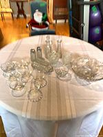 Overview of table with Wexford pieces, large cut glass bowl, custard cups