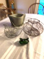 Grouping showing planter, two wire baskets, green glass dish and bird