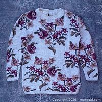 Full front view of white floral knit sweater
