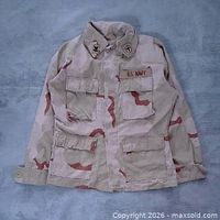 Full front view of jacket showing camouflage pattern, pockets, and overall condition