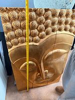 Front view of entire four-panel carved Buddha wall art