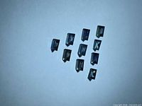 Ten baguette-cut blue-green sapphires on light background