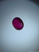 Front view of the oval ruby showing face-up color