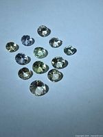 All 12 multicolour Tanzanite stones arranged on white background