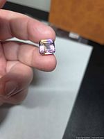 Front view of square octagon step-cut ametrine showing colour split