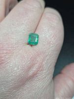 Emerald on hand showing size and colour