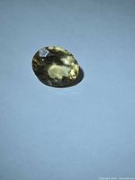 Loose golden yellow oval gemstone front view