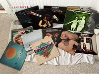 Group shot of 12 LPs laid out including Foreigner 4, Supertramp, Stevie Ray Vaughan, Armageddon, The Tubes, Ten Years After box, Grease soundtrack and others
