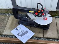 full view of scroll saw with manual