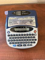 Top view showing Brother PT-1750 label printer, keyboard, LCD