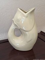 full view of ceramic fish pitcher standing upright