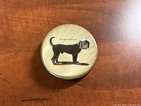 Top view of round paperweight showing dog image and text